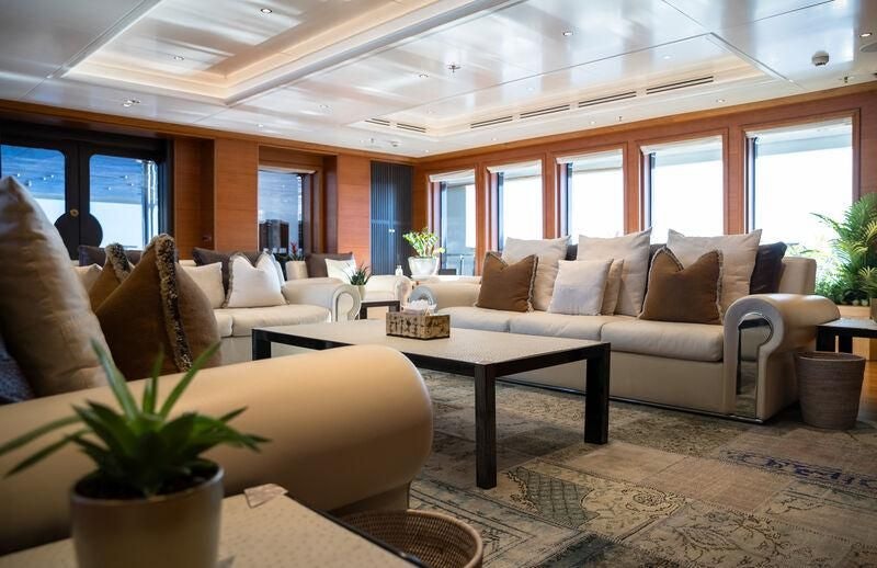 a living room with a couch and a coffee table aboard BOADICEA Yacht for Sale