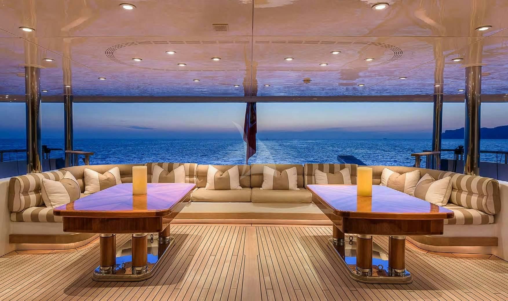 a living room with a table and a couch aboard BOADICEA Yacht for Sale