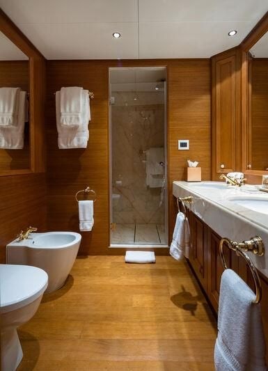 a bathroom with a glass shower aboard BOADICEA Yacht for Sale