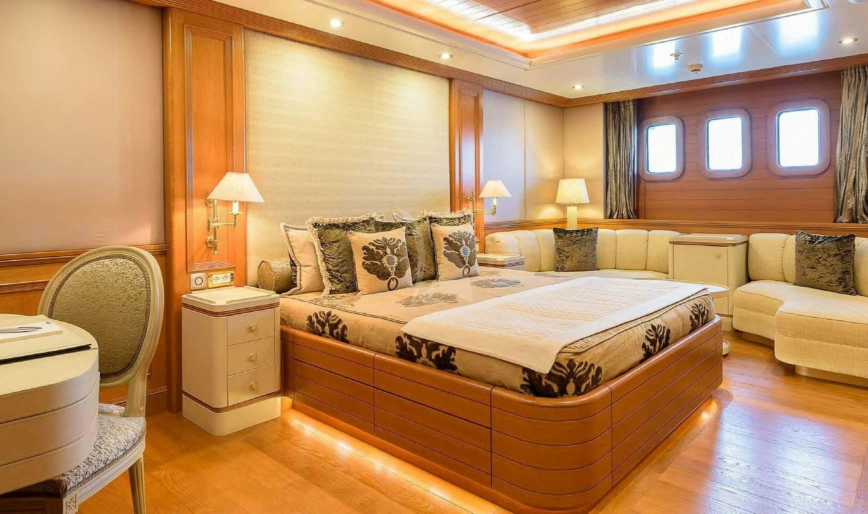 a large bedroom with a bed aboard BOADICEA Yacht for Sale