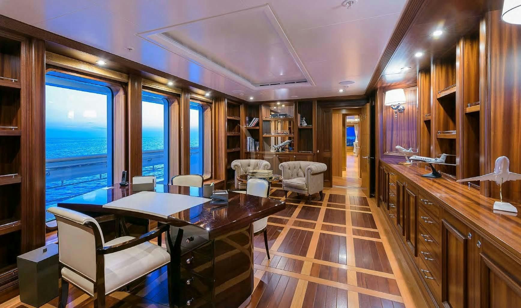 a large room with a table and chairs aboard BOADICEA Yacht for Sale