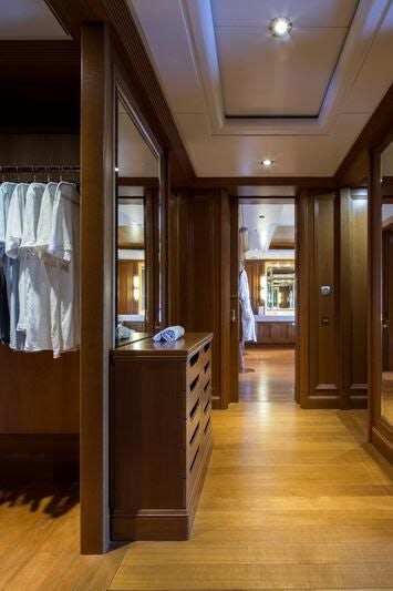 a room with a mirror and a counter with a sink and cabinets aboard BOADICEA Yacht for Sale