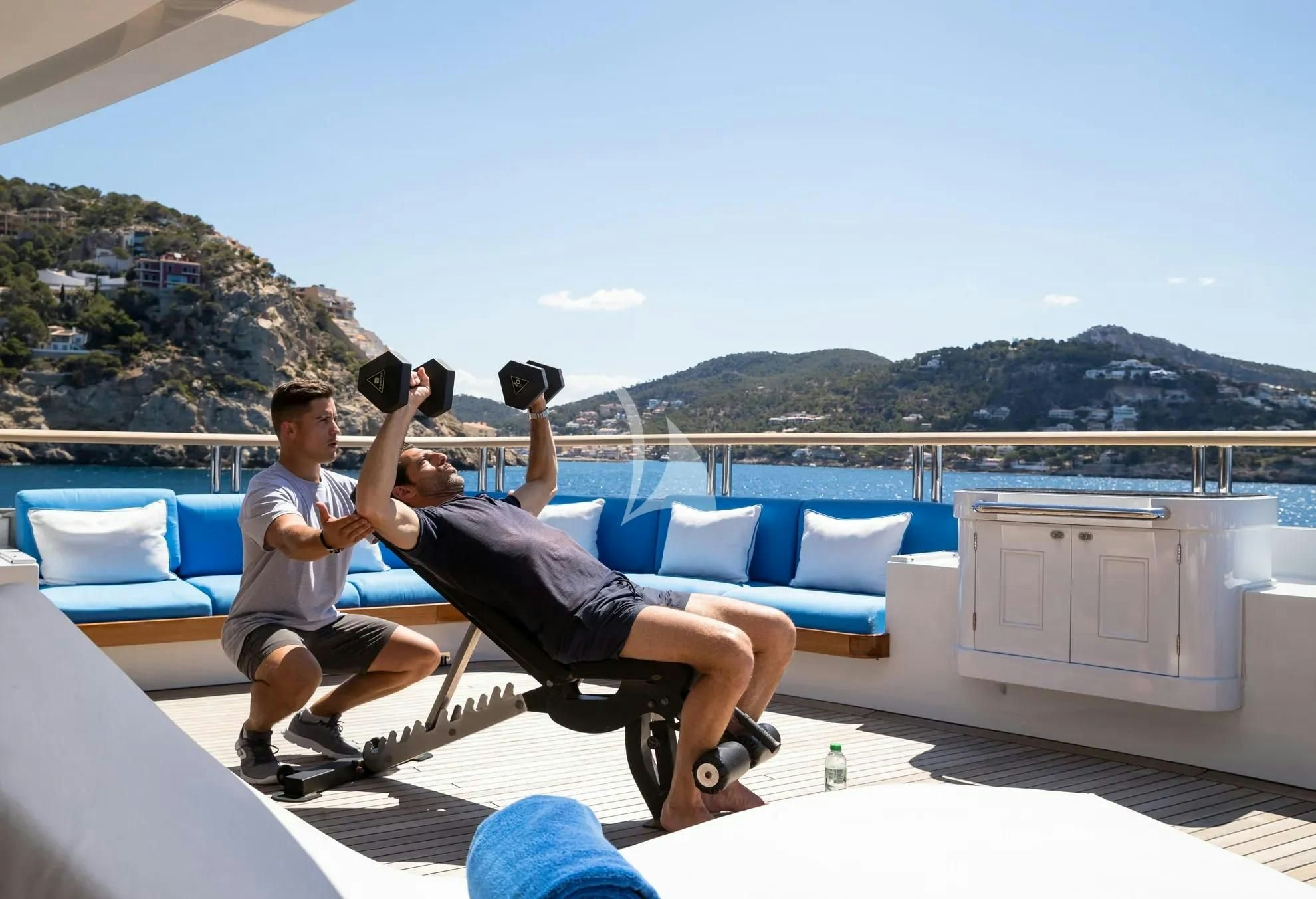 a couple of men sitting on a rooftop with binoculars aboard BOADICEA Yacht for Sale