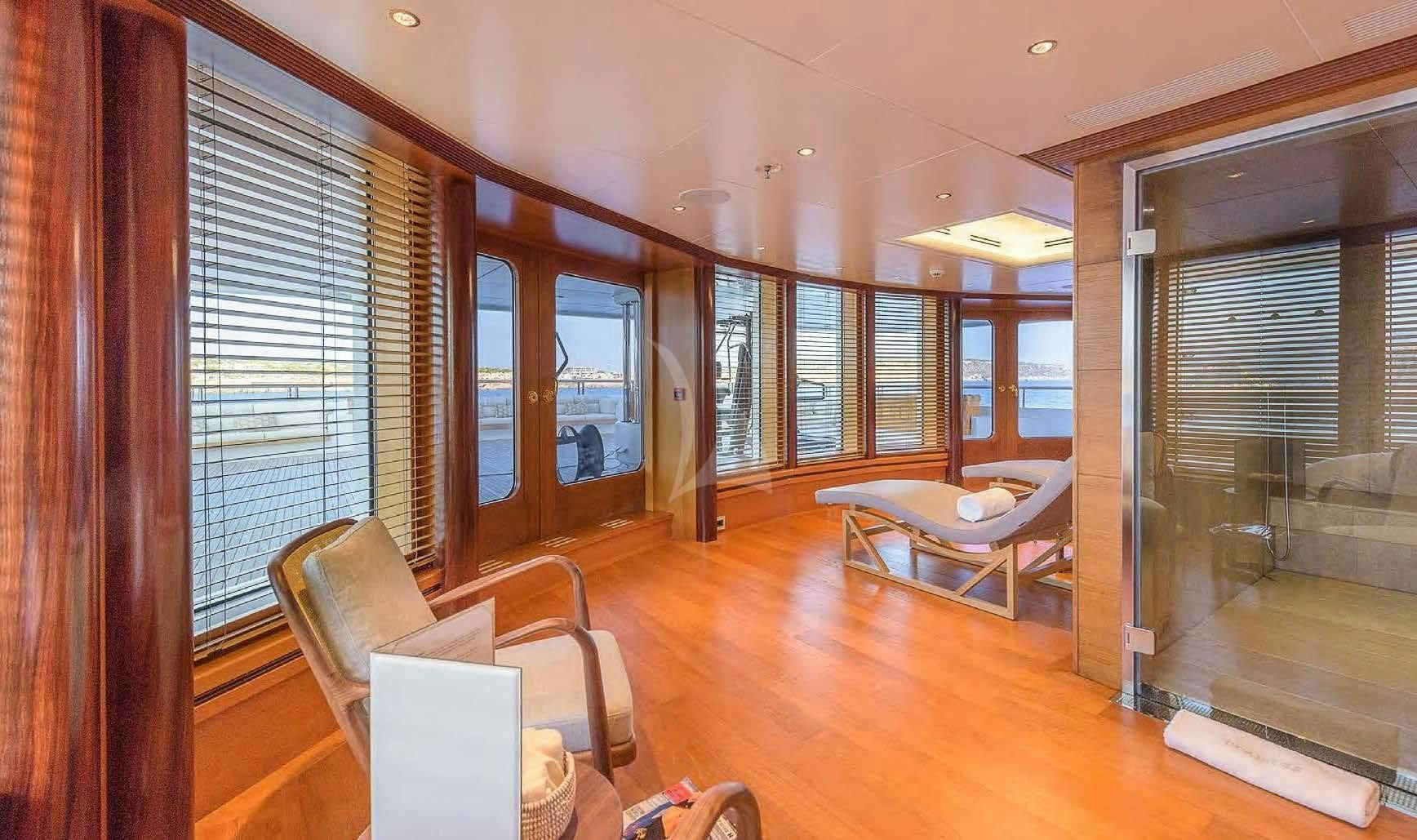 a living room with a wood floor aboard BOADICEA Yacht for Sale
