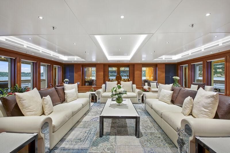 a living room with couches and a table aboard BOADICEA Yacht for Sale