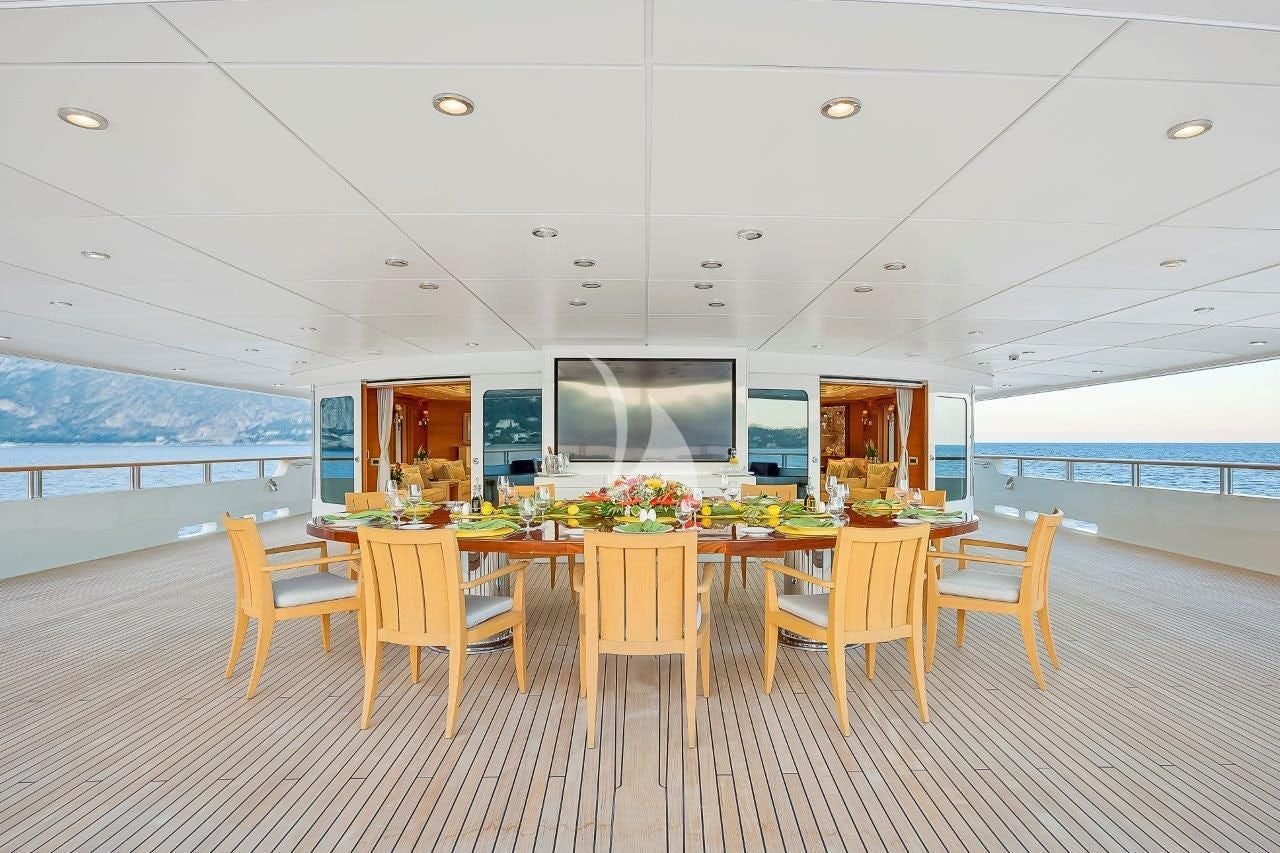 a room with tables and chairs aboard BOADICEA Yacht for Sale