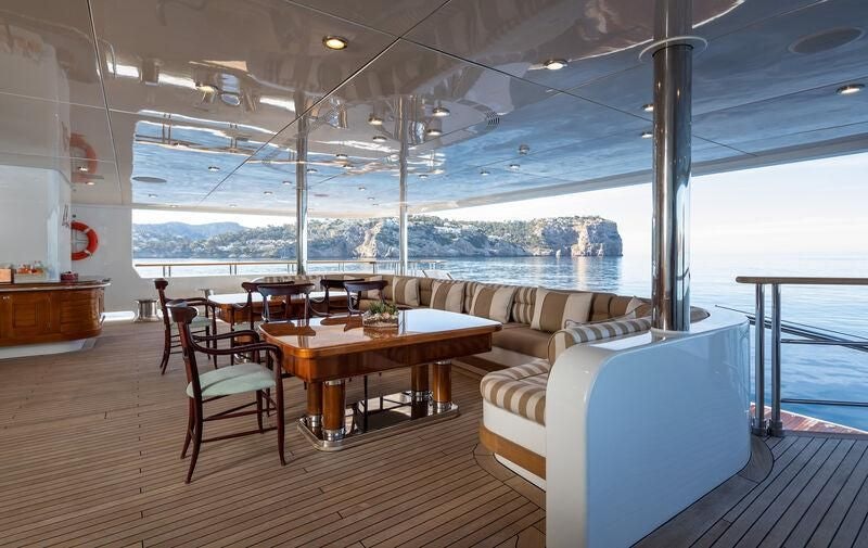 a room with a couch and a table and chairs aboard BOADICEA Yacht for Sale