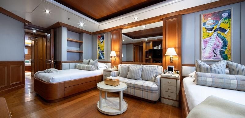 a living room with a couch and a table aboard BOADICEA Yacht for Sale