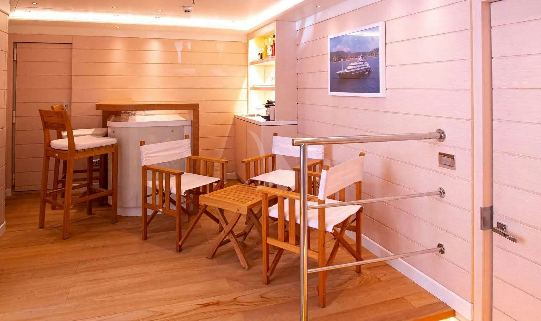 a room with a table and chairs aboard BOADICEA Yacht for Sale