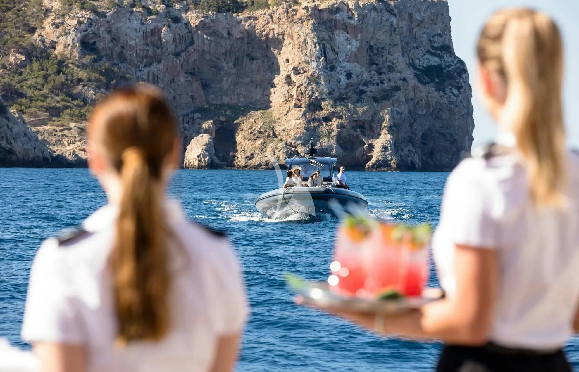 a couple of people looking at a boat in the water aboard BOADICEA Yacht for Sale
