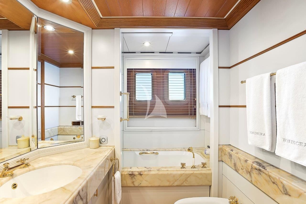 a bathroom with a tub sink and a sink aboard BOADICEA Yacht for Sale