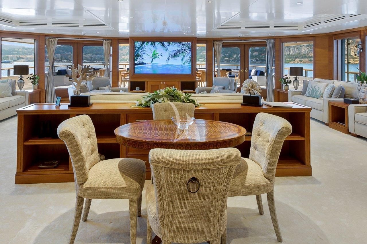 a room with a table and chairs aboard BOADICEA Yacht for Sale