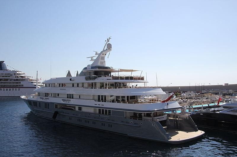 a large white boat in a harbor aboard BOADICEA Yacht for Sale