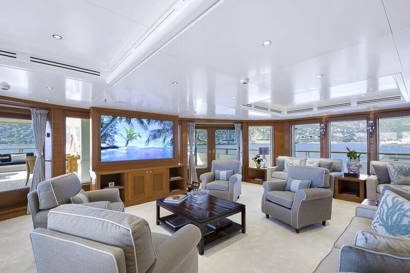 a living room with a large screen aboard BOADICEA Yacht for Sale