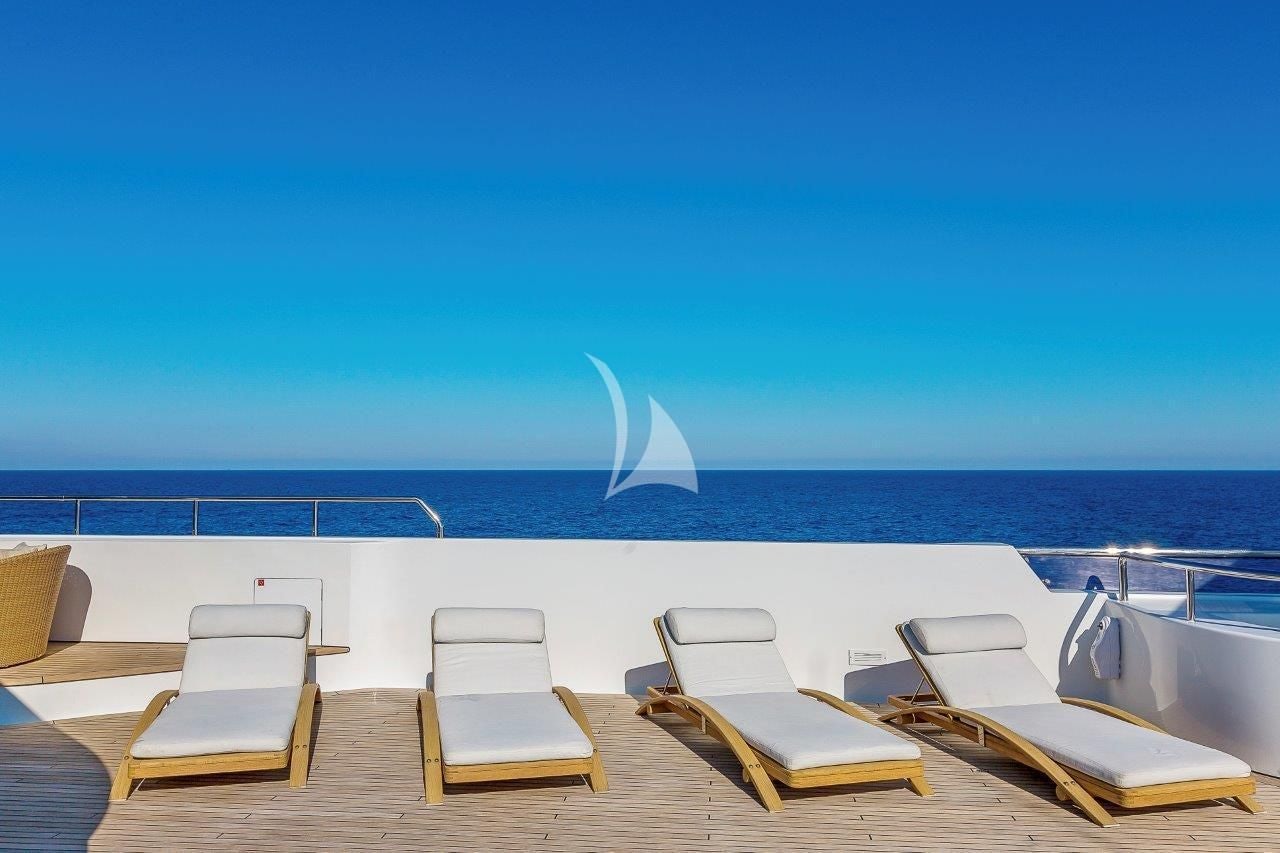 chairs and a table on a beach aboard BOADICEA Yacht for Sale