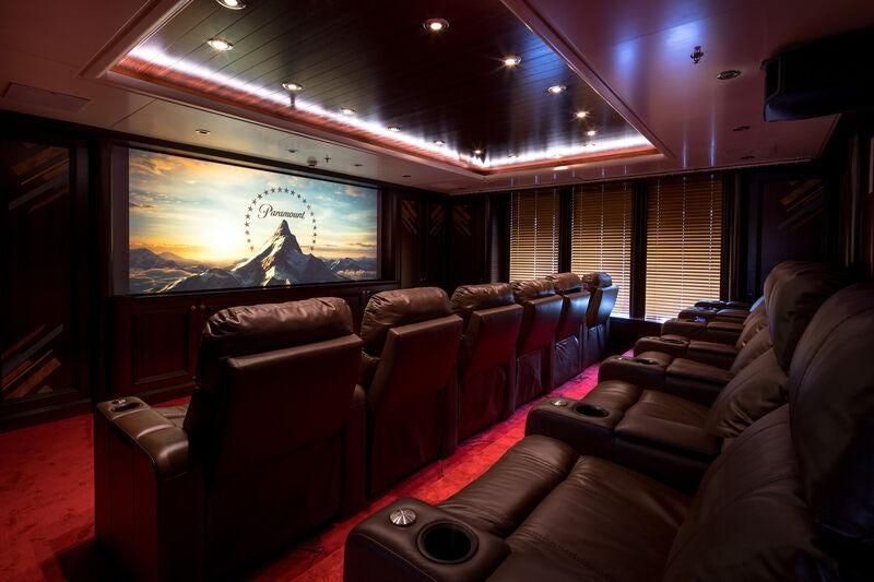 a room with leather couches and a television aboard BOADICEA Yacht for Sale
