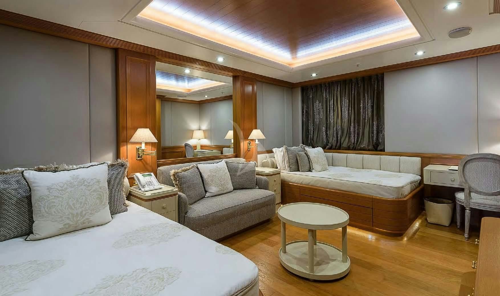 a hotel room with a bed and a couch aboard BOADICEA Yacht for Sale