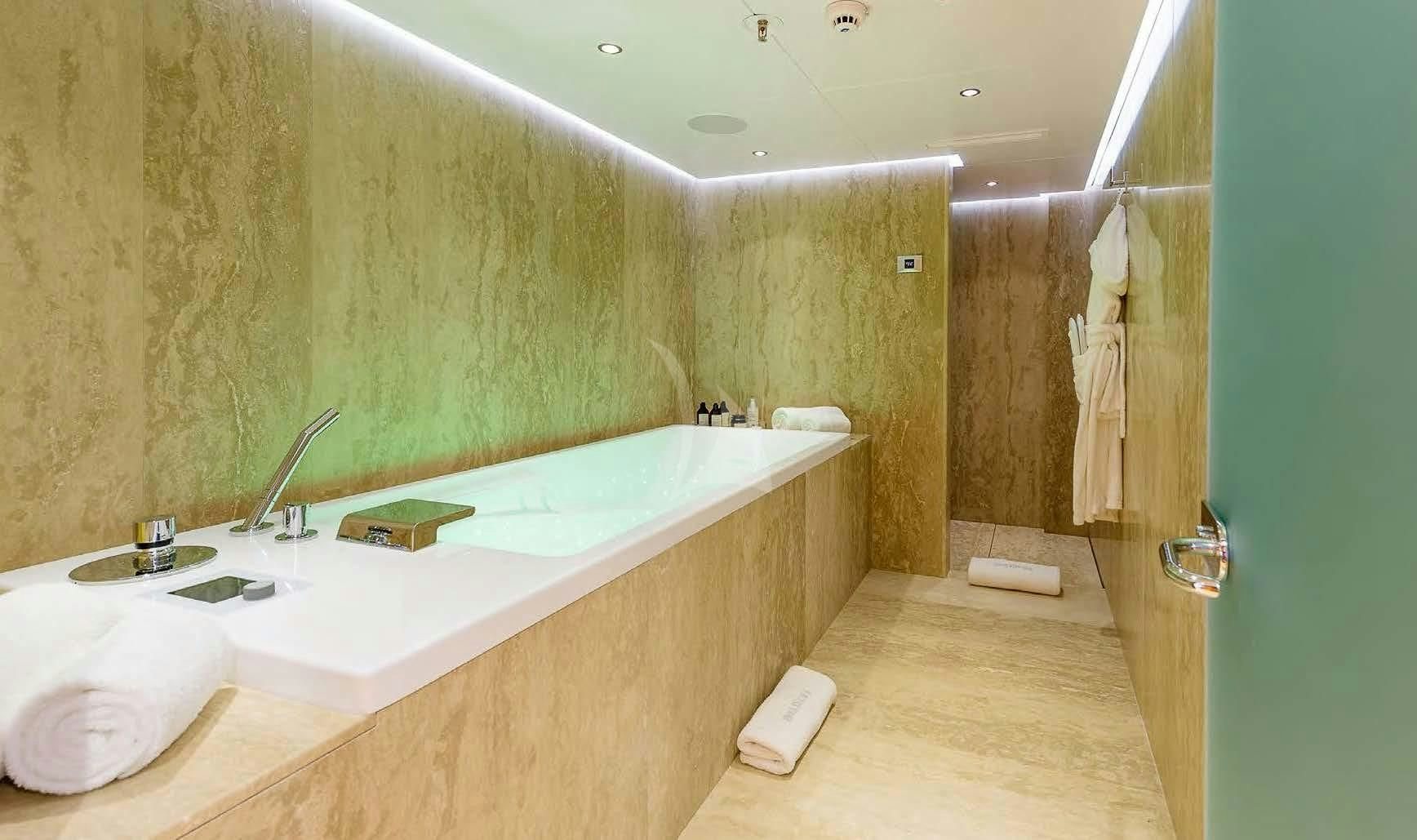 a bathroom with a sink and a bathtub aboard BOADICEA Yacht for Sale