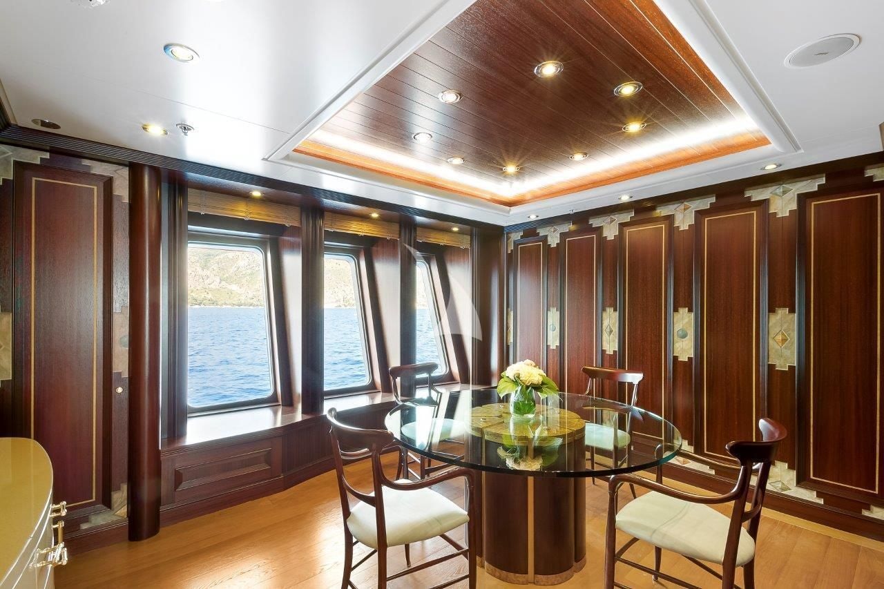 a room with a table and chairs aboard BOADICEA Yacht for Sale