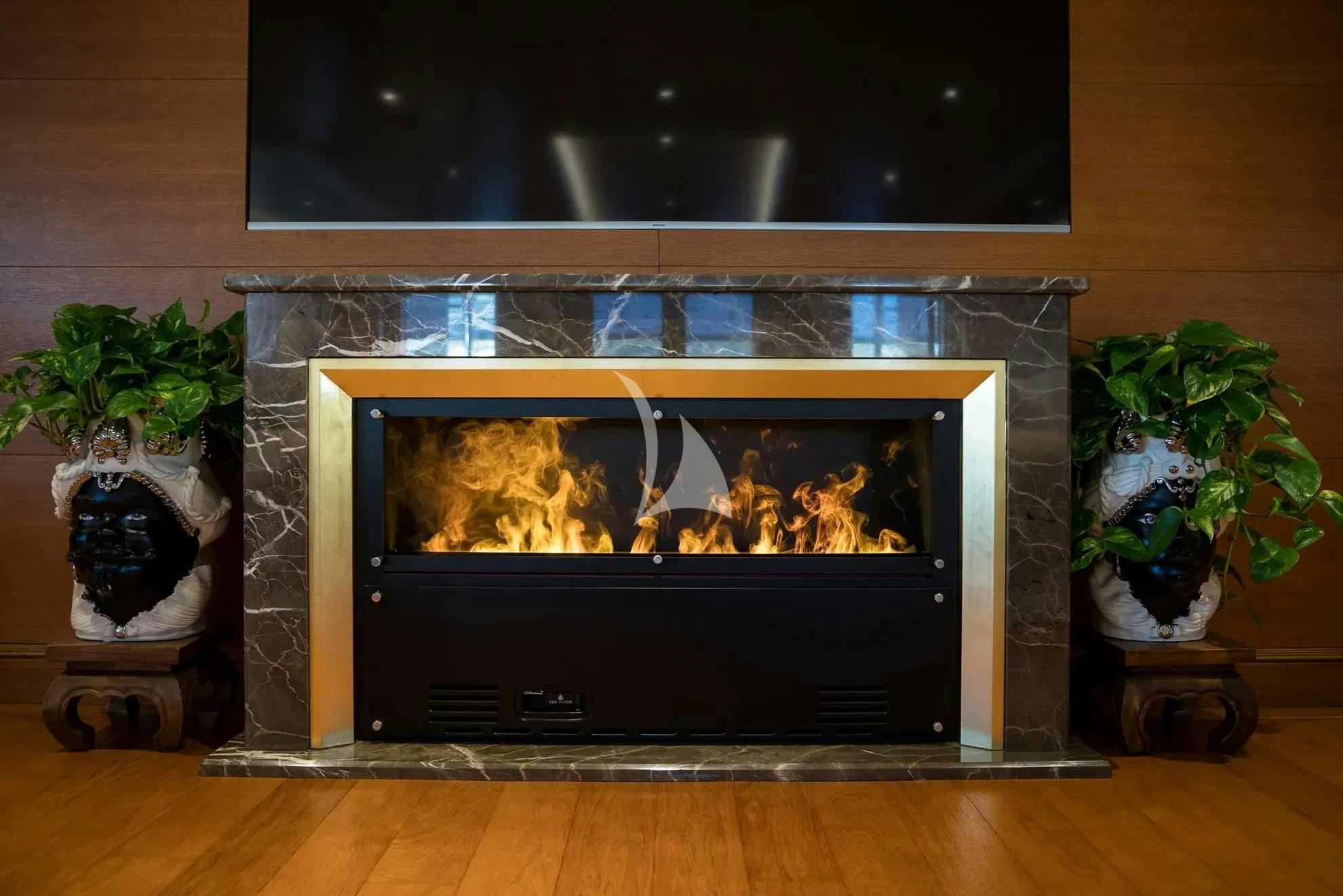 a fireplace with a painting on it aboard BOADICEA Yacht for Sale