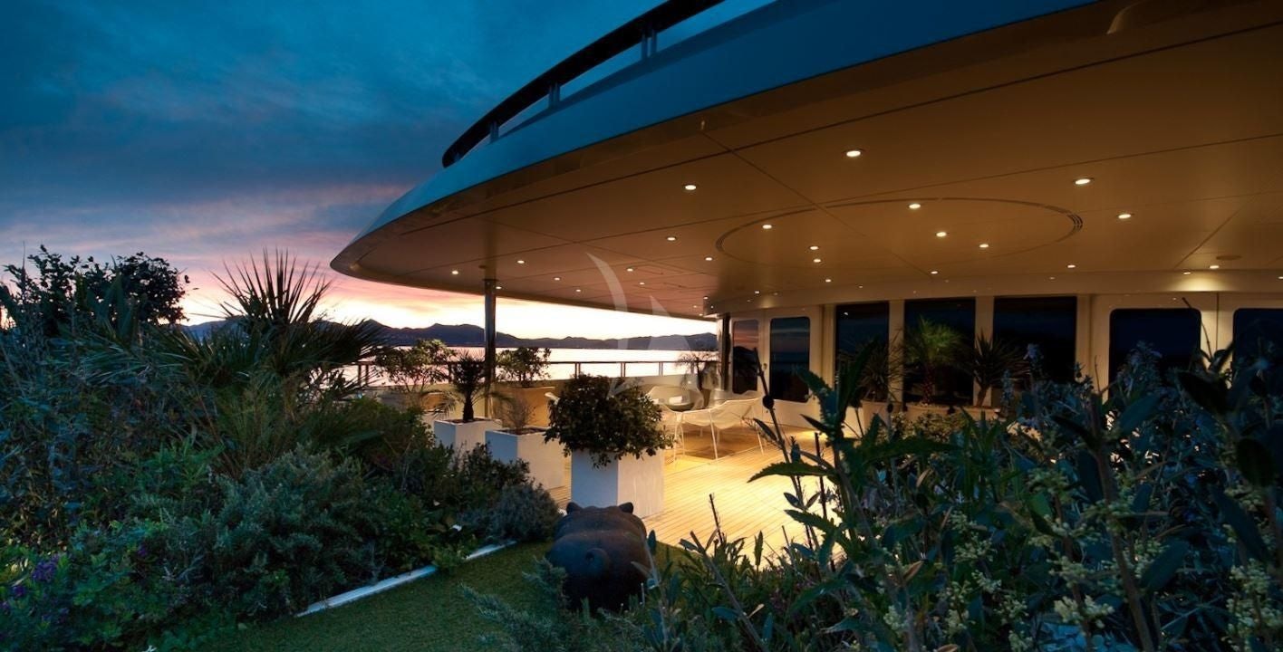 a house with a large patio and a large black umbrella aboard BOADICEA Yacht for Sale