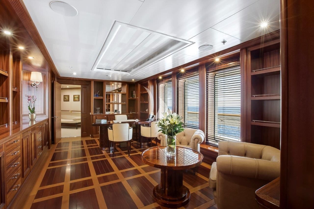 a large living room with a wood floor aboard BOADICEA Yacht for Sale