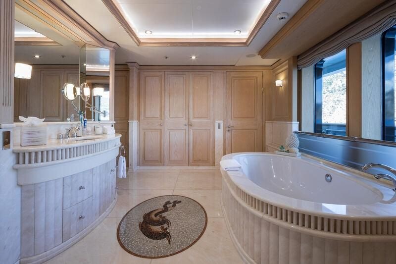 a bathroom with a tub sink and cabinets aboard BOADICEA Yacht for Sale