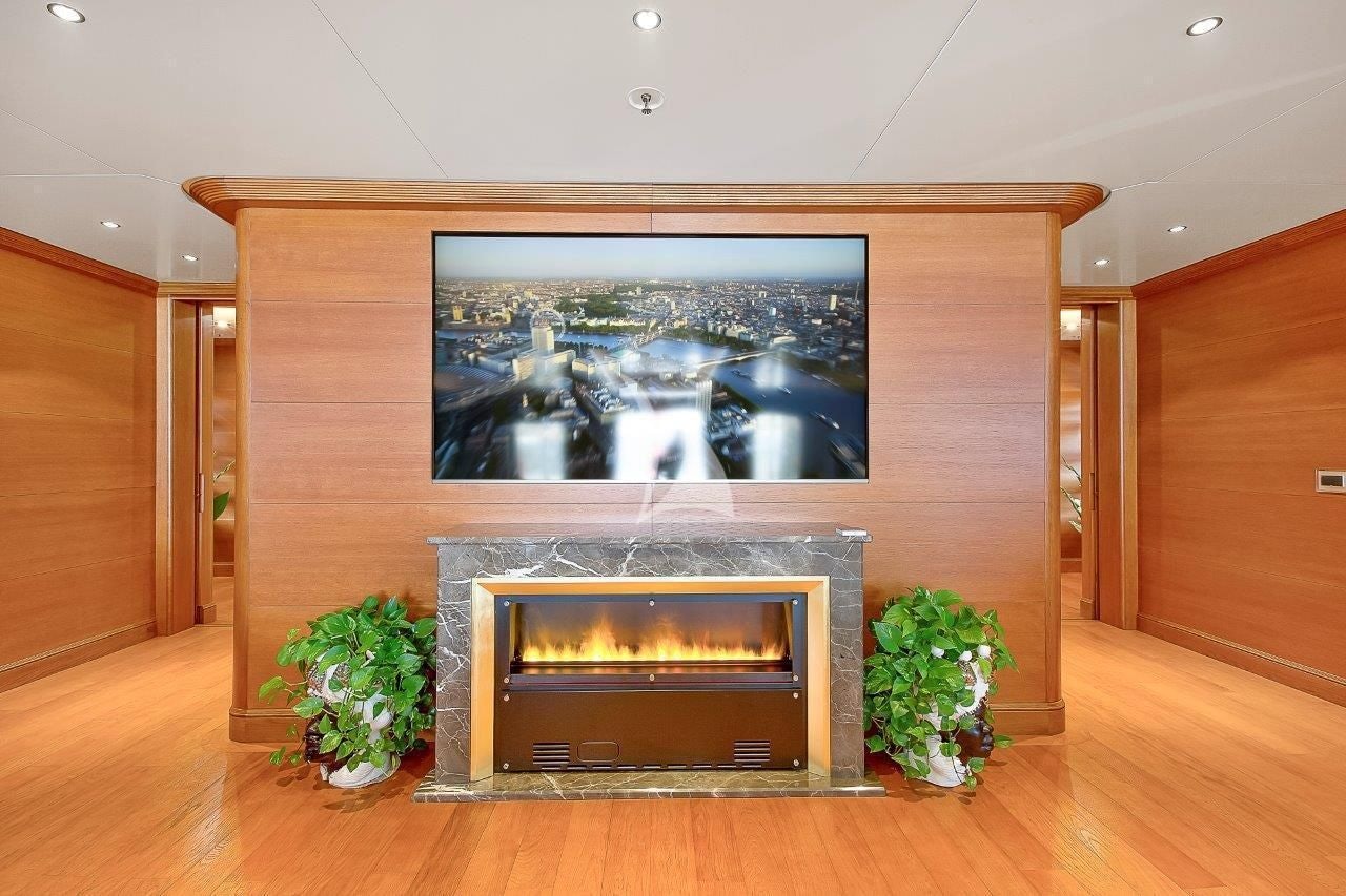 a fireplace with a large painting aboard BOADICEA Yacht for Sale