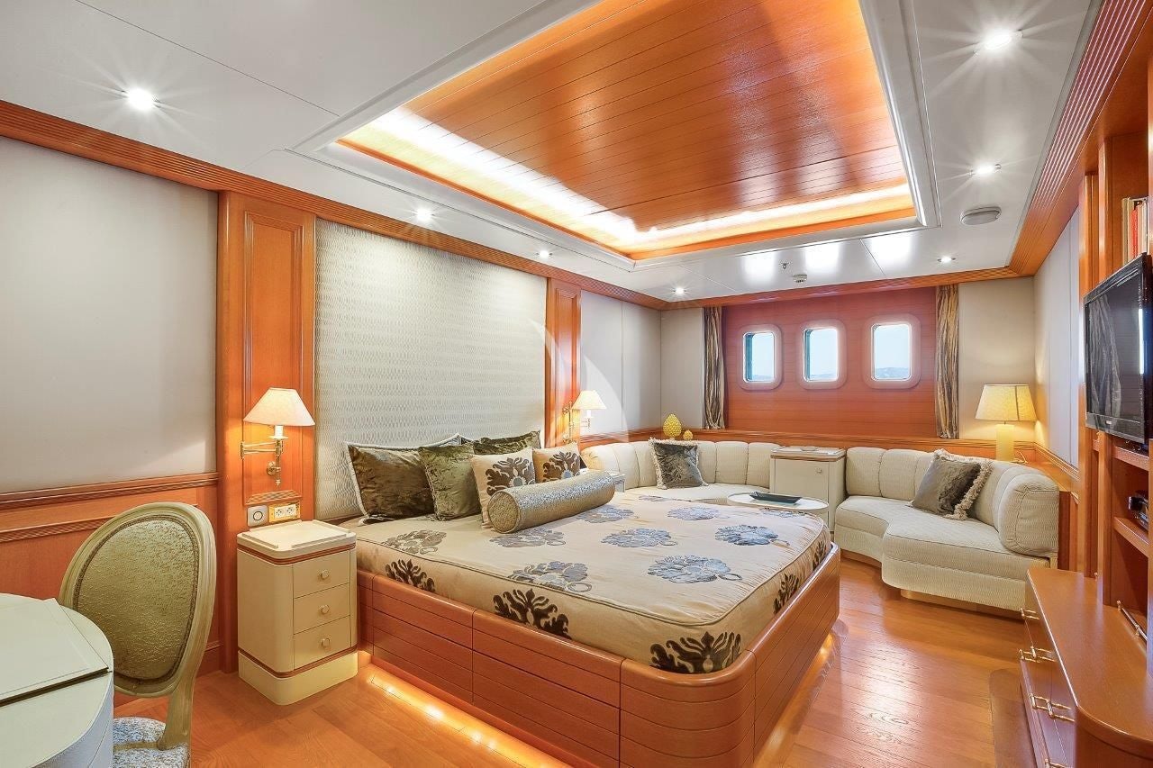 a large living room with a large bed and a couch aboard BOADICEA Yacht for Sale