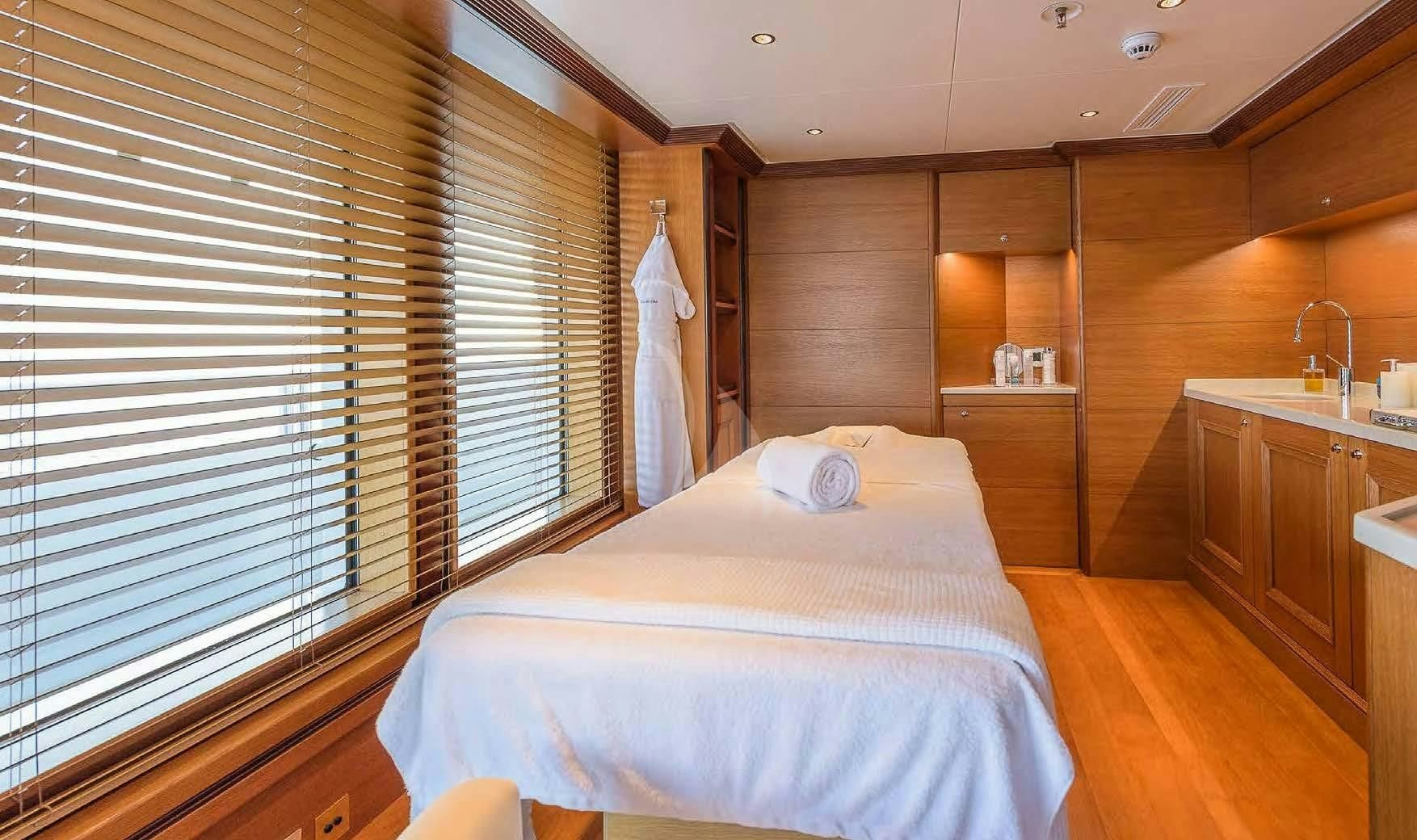 a bedroom with a bed and a window aboard BOADICEA Yacht for Sale