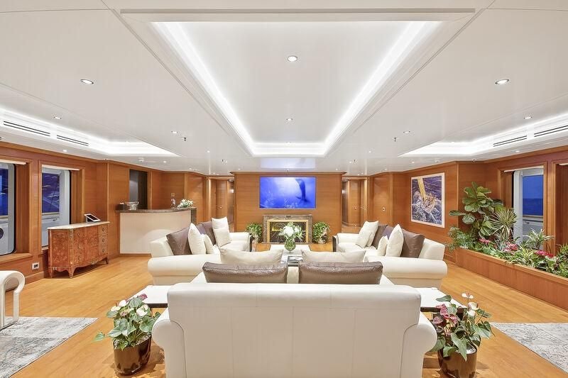 a living room with white couches aboard BOADICEA Yacht for Sale