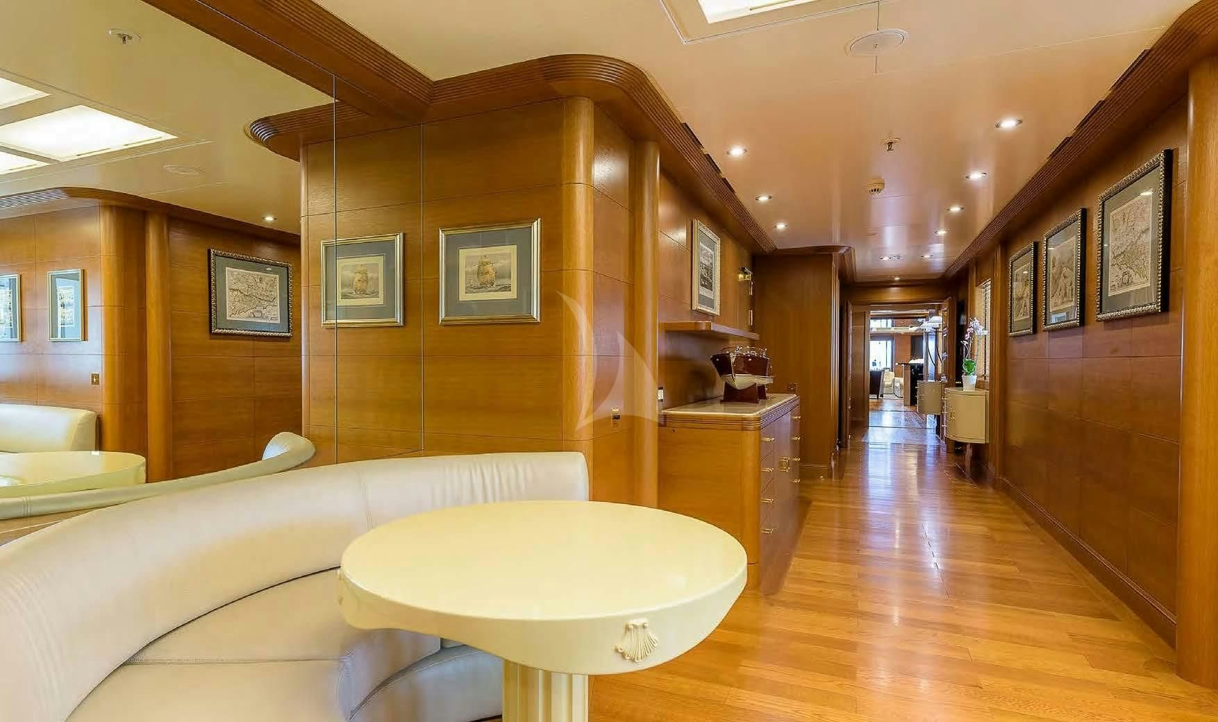 a room with a table and couch aboard BOADICEA Yacht for Sale
