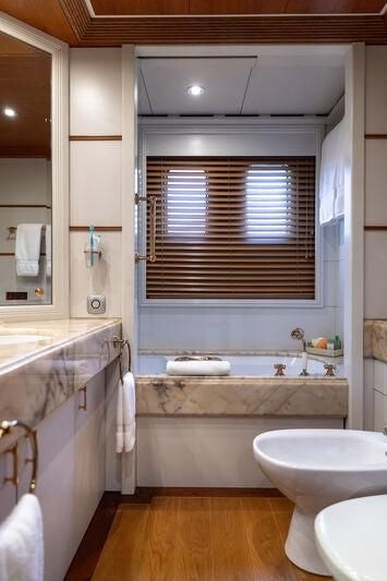 a bathroom with a tub sink and toilet aboard BOADICEA Yacht for Sale
