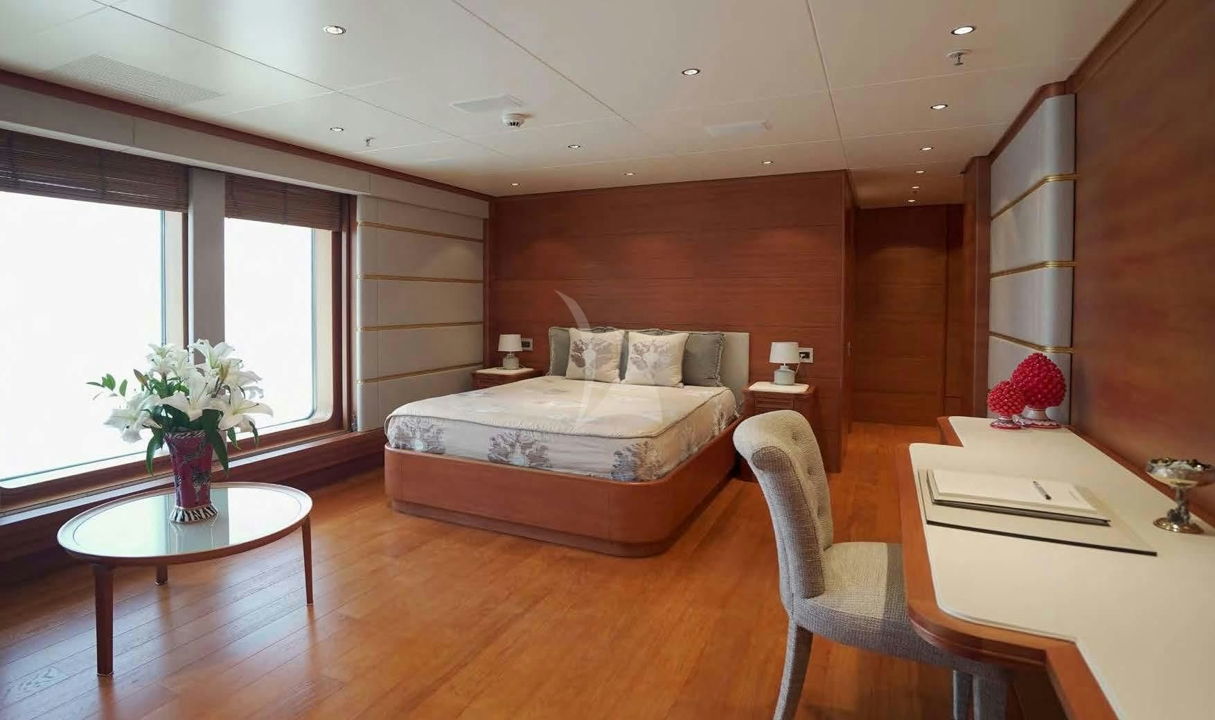 a room with a bed and a table aboard BOADICEA Yacht for Sale