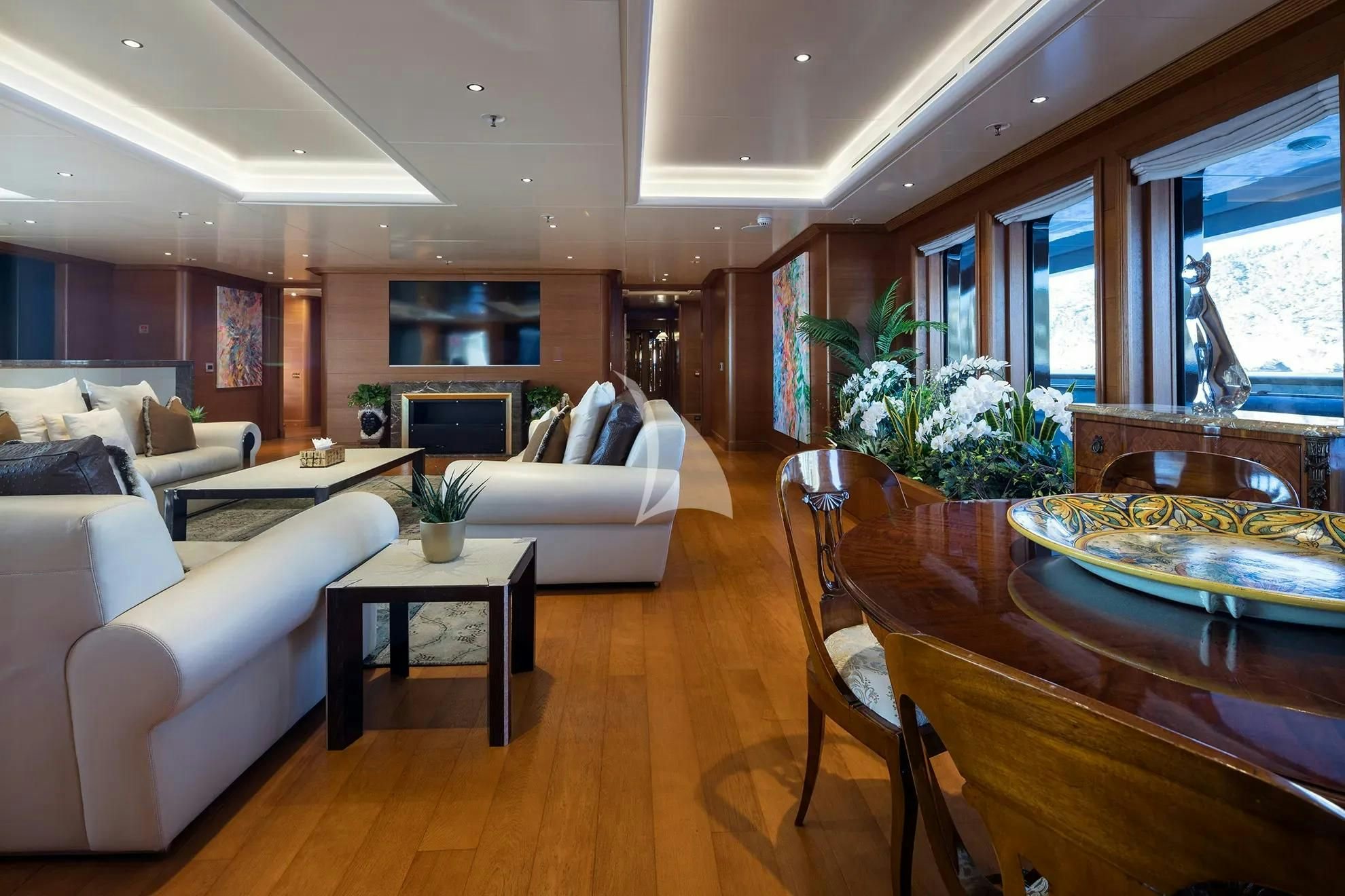a living room with a large table and couches aboard BOADICEA Yacht for Sale