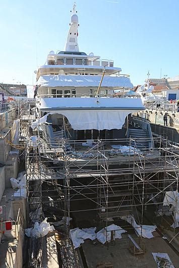 a large white boat in a harbor aboard BOADICEA Yacht for Sale