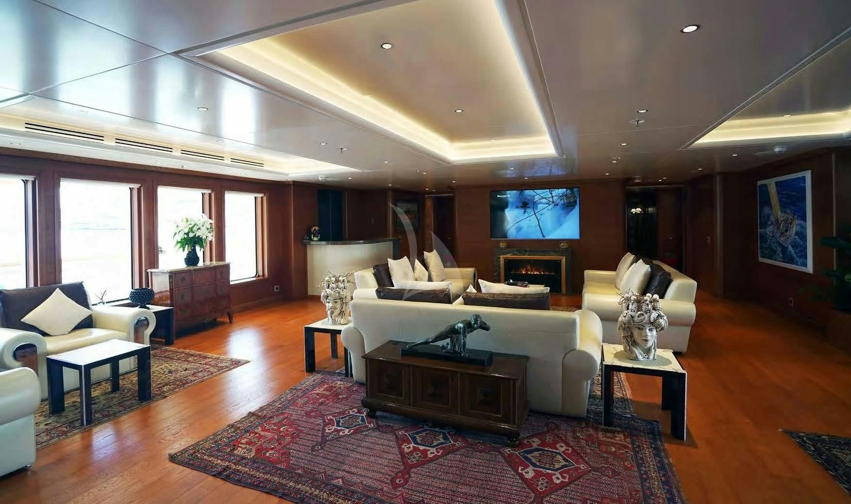 a living room with a large red rug and a white couch aboard BOADICEA Yacht for Sale