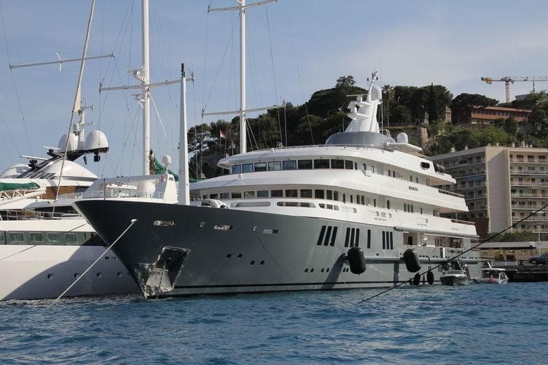 a large white boat in a harbor aboard BOADICEA Yacht for Sale