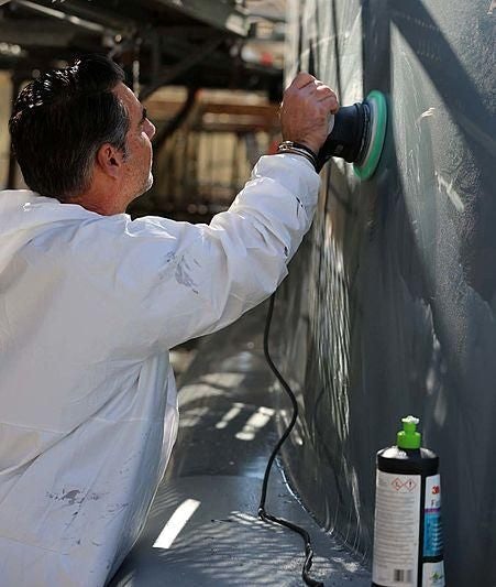 a man pouring water into a glass aboard BOADICEA Yacht for Sale