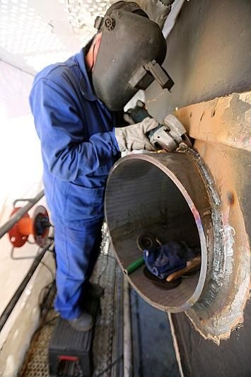 a man working on a machine aboard BOADICEA Yacht for Sale