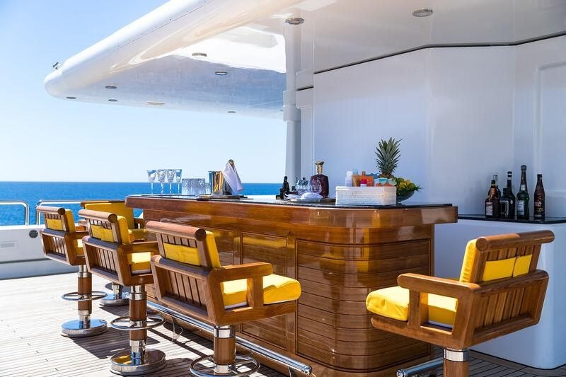 a room with a table and chairs aboard BOADICEA Yacht for Sale