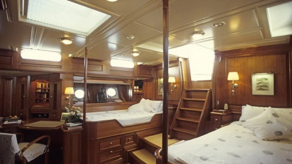 a room with a bed and a mirror aboard FOFTEIN Yacht for Sale