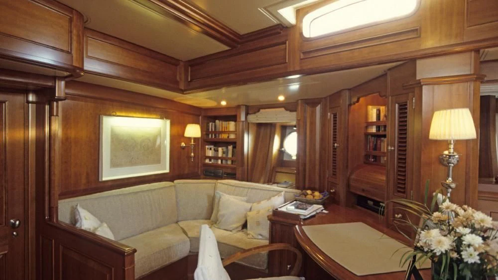 a living room with a couch and a table aboard FOFTEIN Yacht for Sale