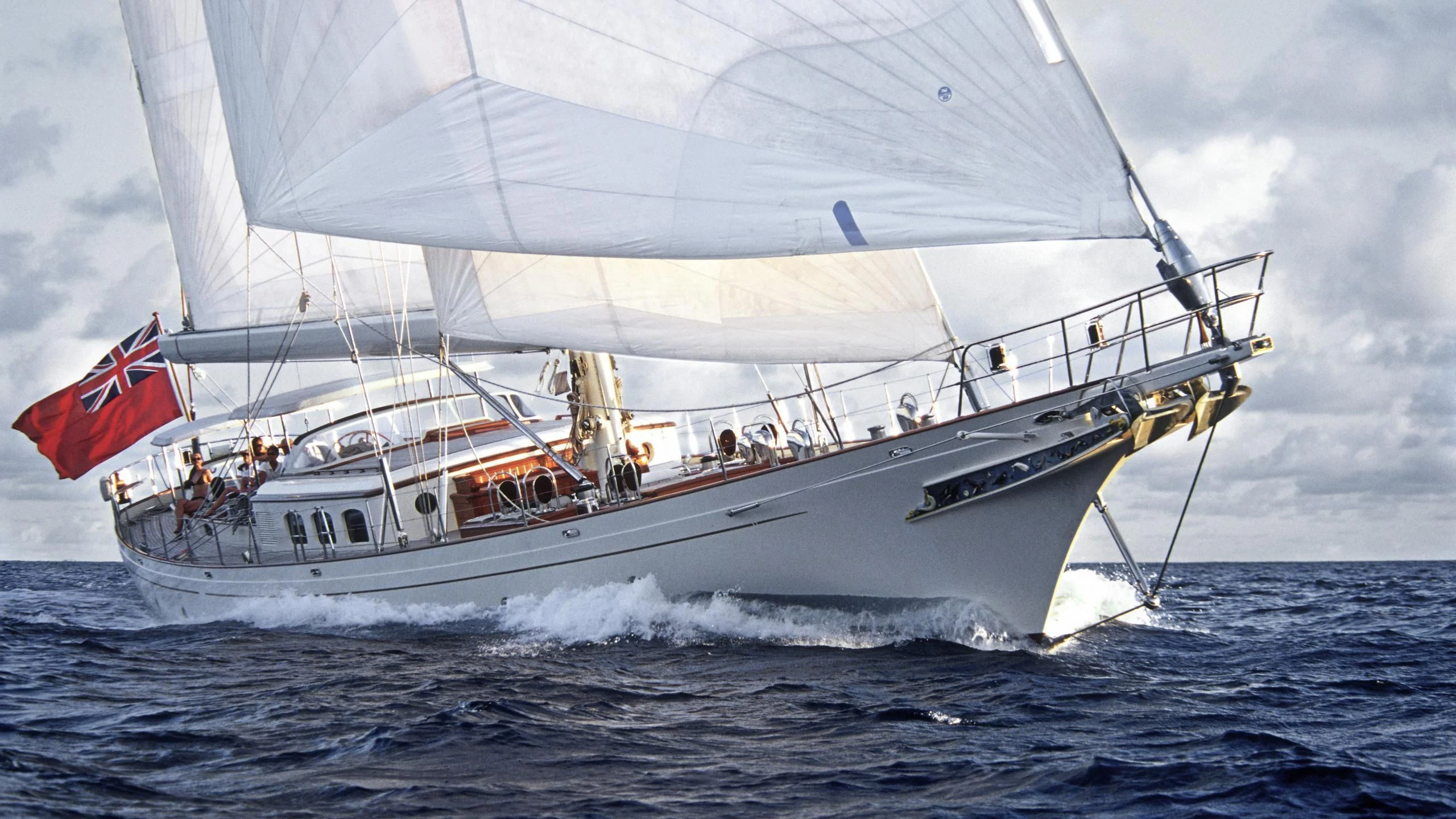 a large white boat with a flag on it aboard FOFTEIN Yacht for Sale