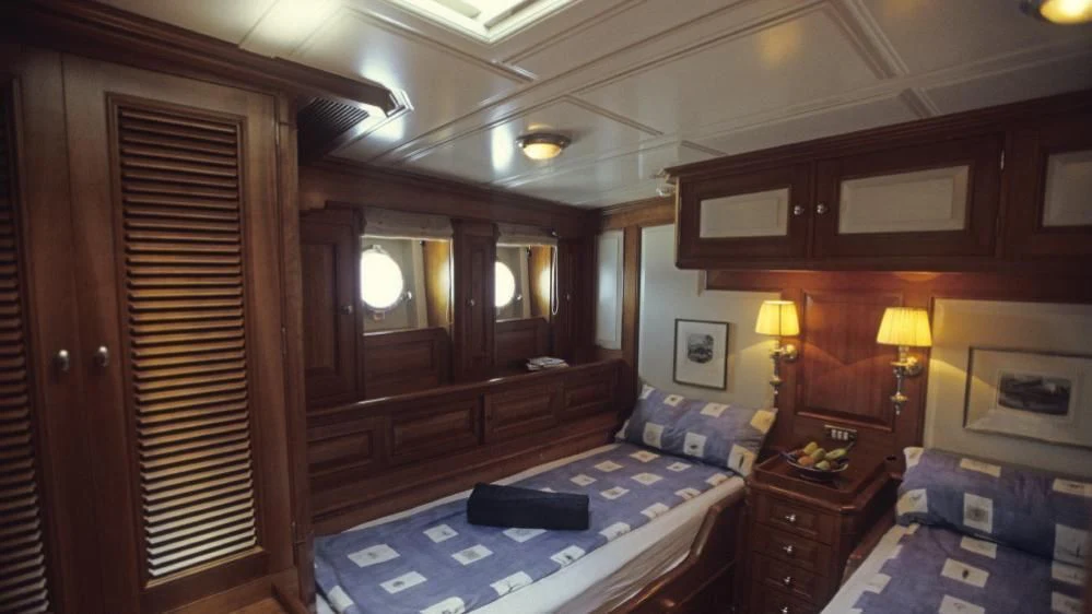 a bedroom with a bed and a closet aboard FOFTEIN Yacht for Sale