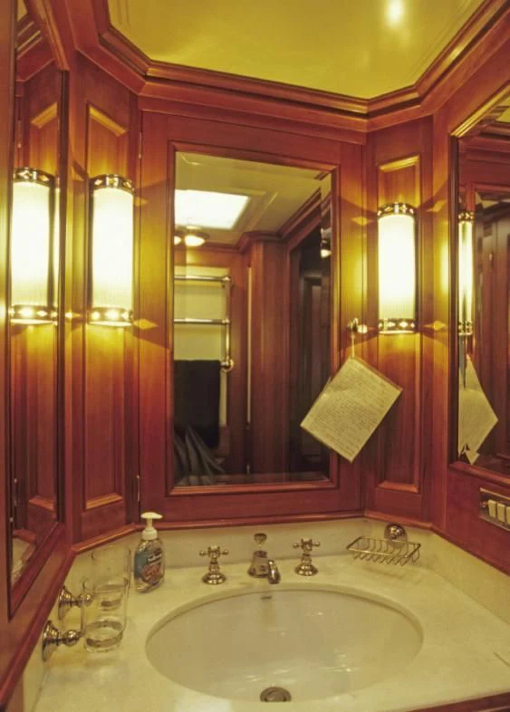 a bathroom with a large mirror aboard FOFTEIN Yacht for Sale