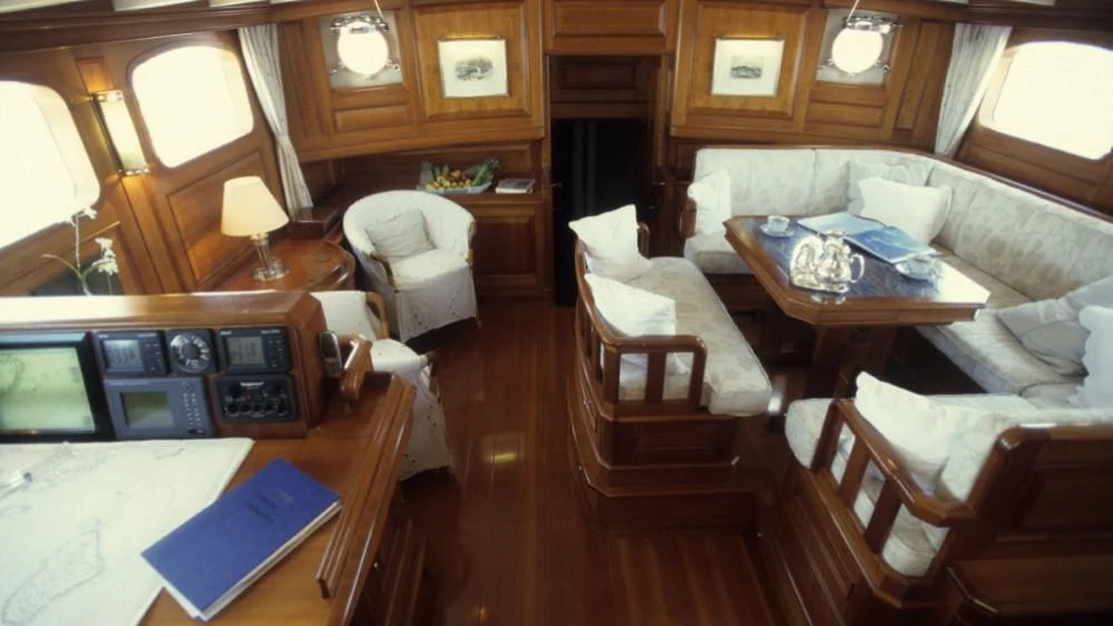 a living room with a couch and a table aboard FOFTEIN Yacht for Sale