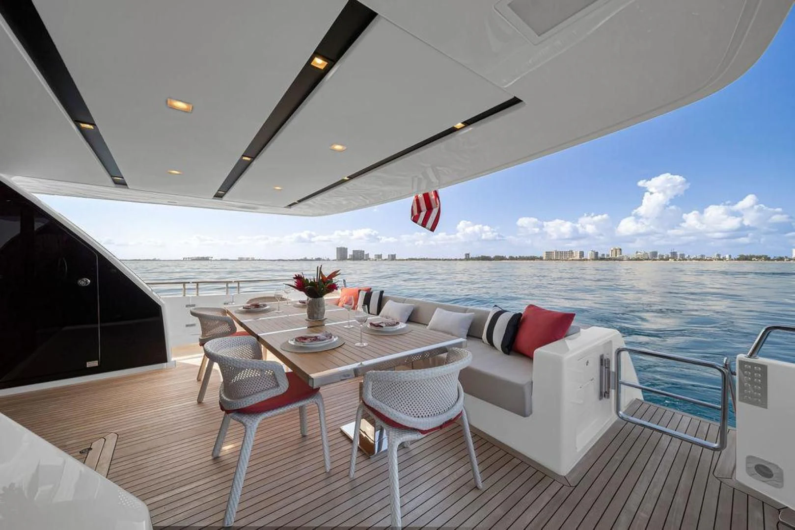 a large patio with a table and chairs on it aboard JUJU Yacht for Sale
