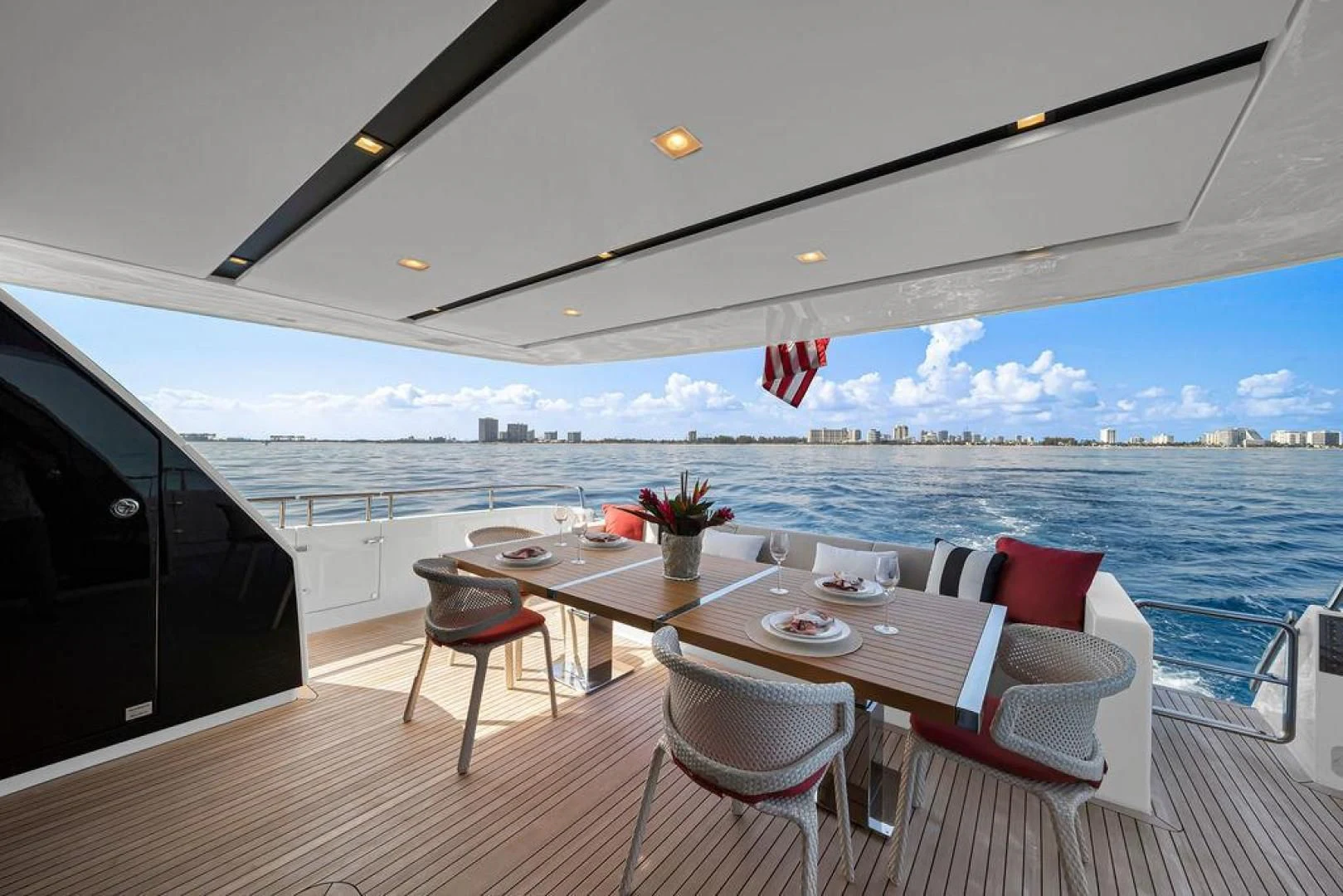 a table on a deck overlooking the ocean aboard JUJU Yacht for Sale