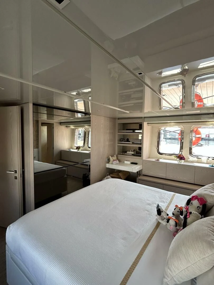 a bedroom with a bed and a window aboard JUJU Yacht for Sale
